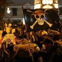Demonstrators holding a flag of the manga series "One Piece" clash with anti-riot police officers during protest against Peru's interim President Jose Jeri in Lima