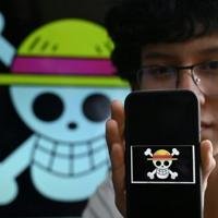 Peruvian student Wildar Lozano, 20, of the Gen Z movement, shows the "One Piece" manga flag
