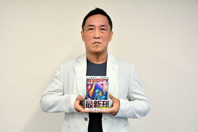 Kouji Mori, keeper of the Berserk ending notes, holding a new volume
